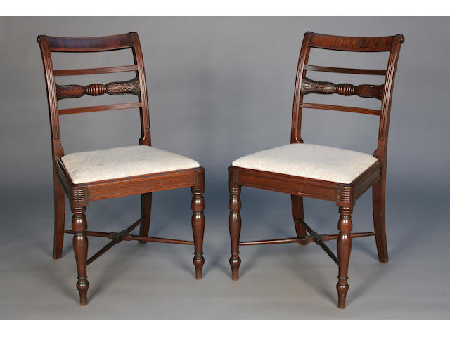 A set of eight late George III mahogany dining chairs