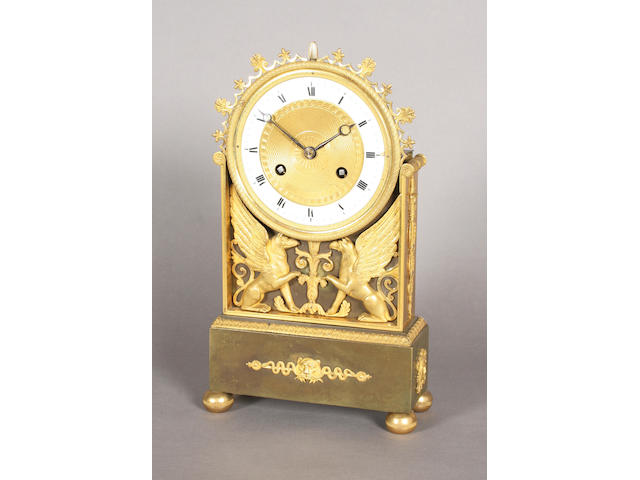 A mid-19th century Empire style gilt bronze and bronze mantel clock