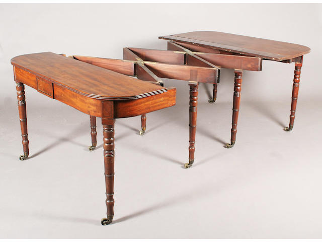 A late George III figured mahogany concertina action extending dining table