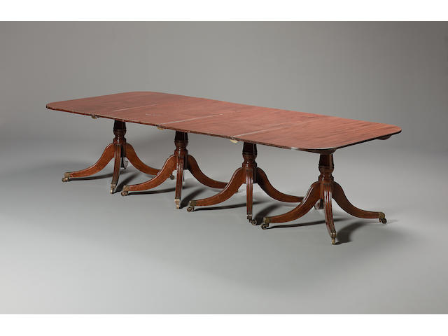 A Regency style four pillar mahogany dining table
