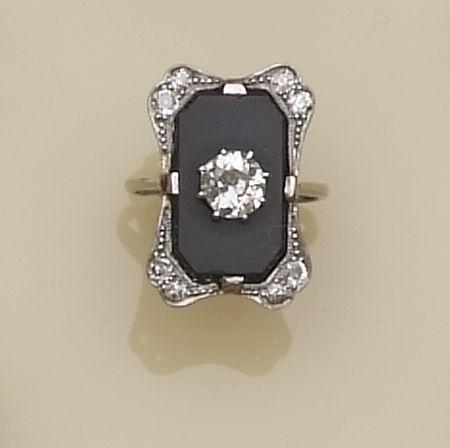 A diamond and onyx set panel ring