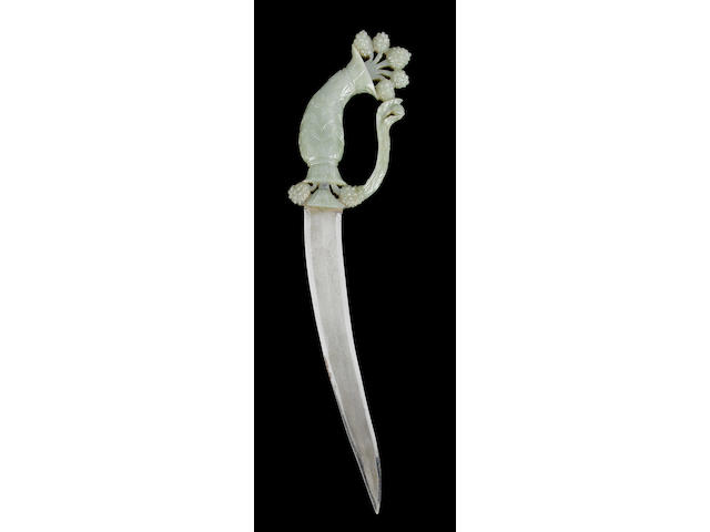 An elegant Mughal jade dagger handle with attached blade;