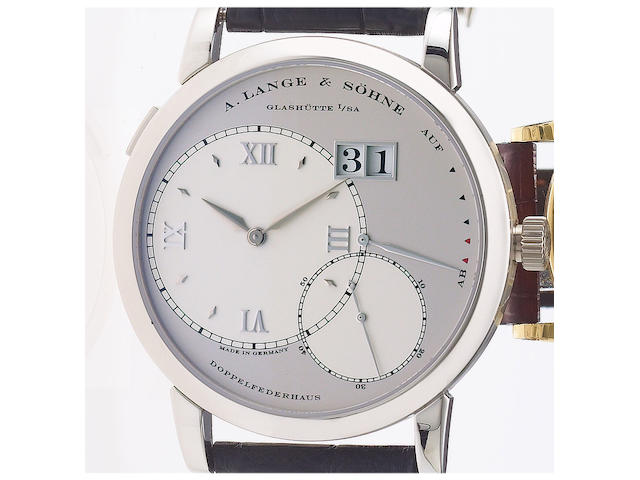 A. Lange & S&#246;hne. A fine and rare platinum wristwatch with oversized date and power-reserve with fitted factory box and papersLange 1, Ref:115.025. Movement No.38765 Sold November 2004