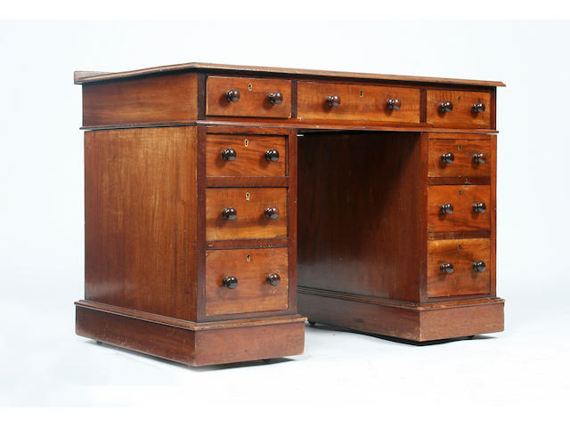A small early Victorian walnut pedestal desk