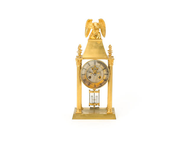 An interesting gilt brass portico clock with compound pendulum,