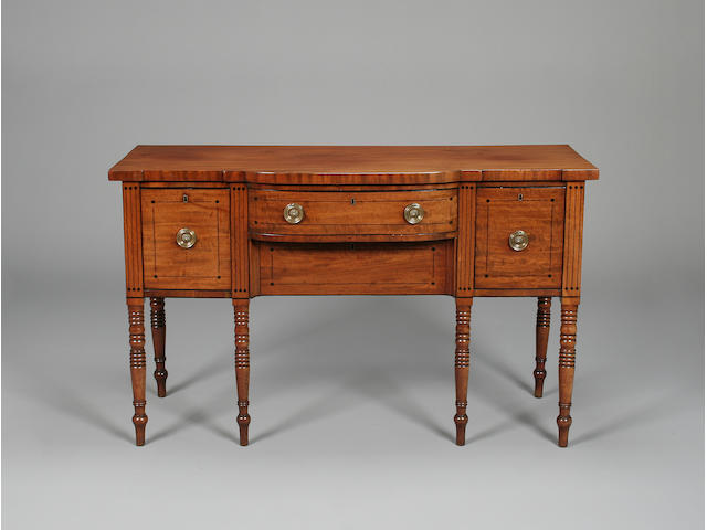 A George IV mahogany and boxwood strung bow breakfront sideboard