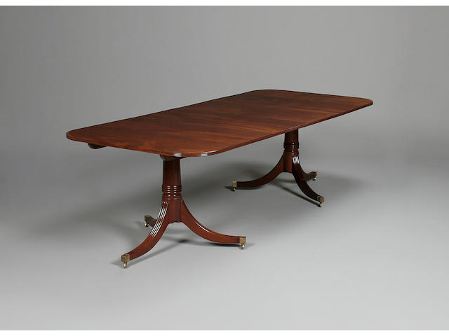A George III style mahogany twin pedestal dining table