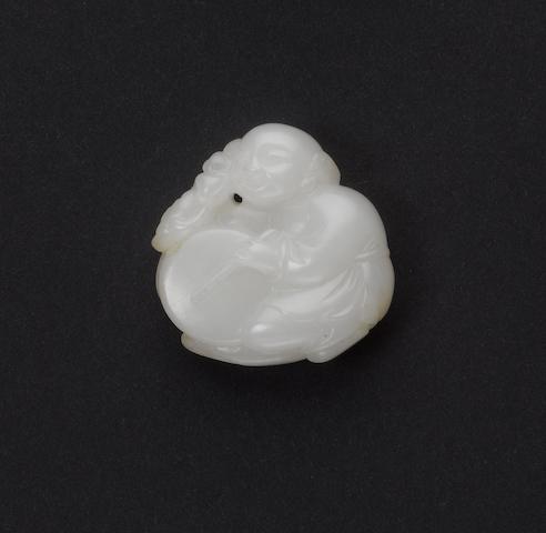 An almost white jade of a boy beating a drum;