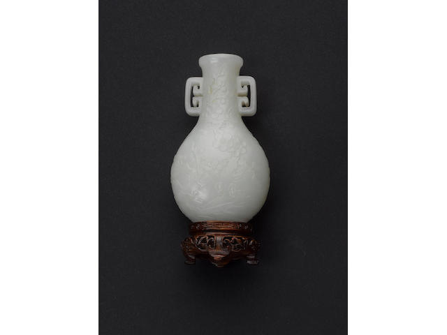 A jade vase of flattened oval-section with geometric handles;
