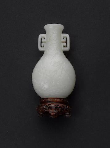 A jade vase of flattened oval-section with geometric handles;