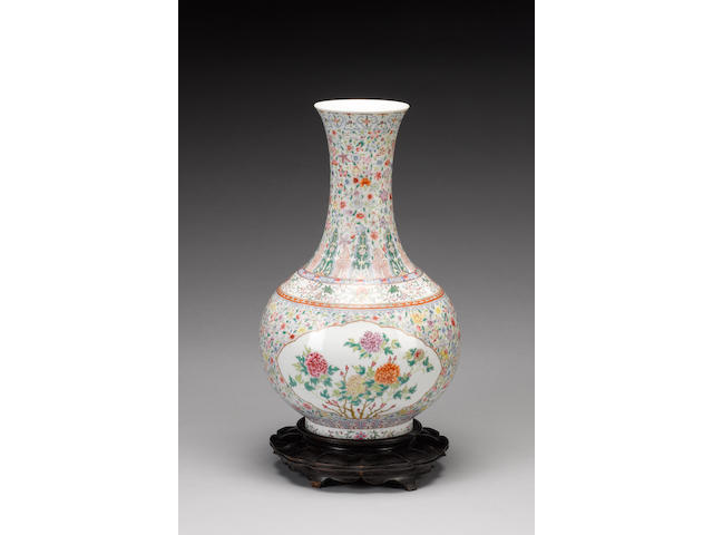 A famille rose bottle vase decorated with a 'mille-fleurs' ground;