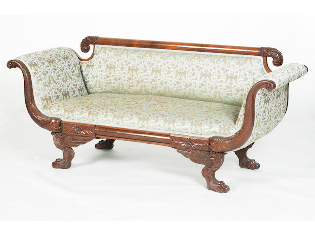 An early 19th century carved mahogany settee