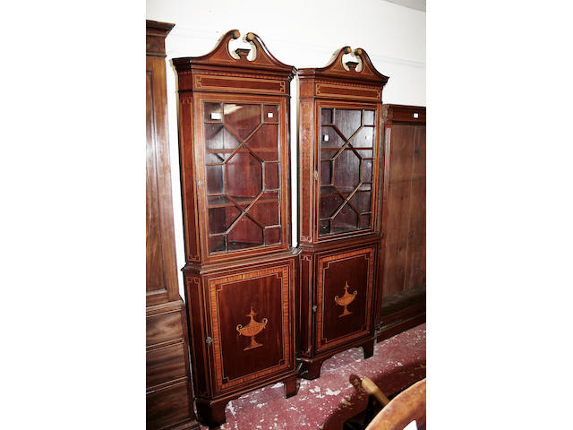 A pair of Edwardian mahogany corner cabinets