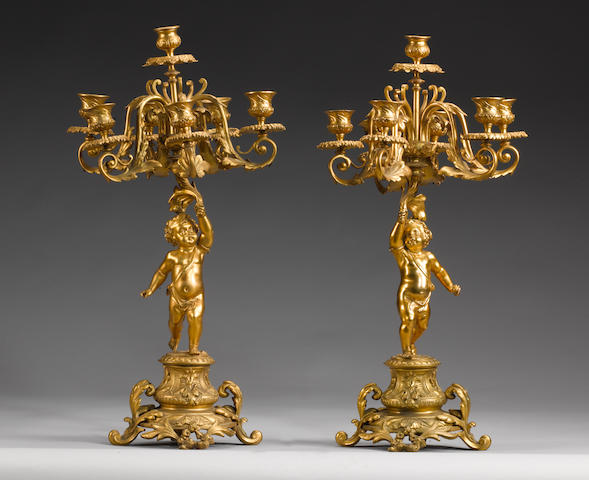 A pair of late 19th century French gilt bronze figural seven light candelabra