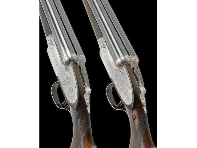 A pair of 12-bore single-trigger self-opening sidelock ejector guns by J. Purdey, no. 27131/2 In their leather motor-case