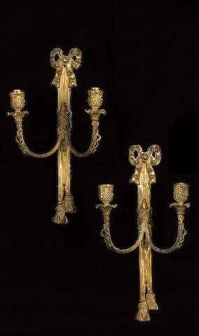 A set of four 19th century gilt metal twin light wall appliques