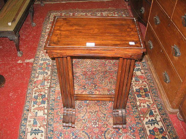 A nest of four rosewood tables