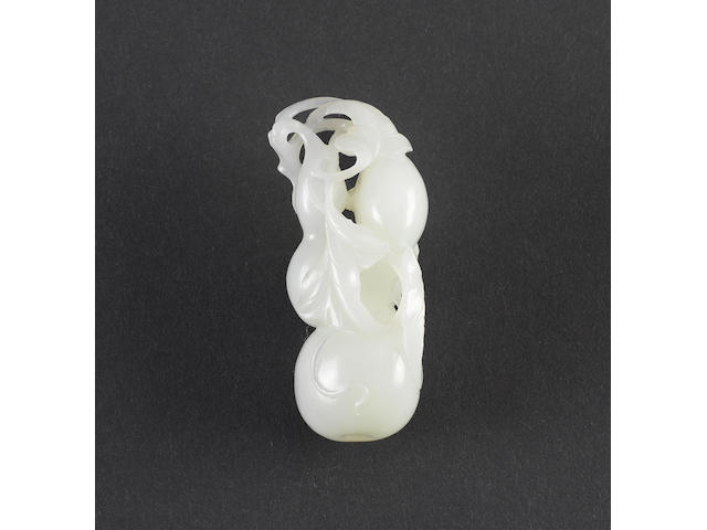 A small, almost white, jade carved as a flowering gourd;