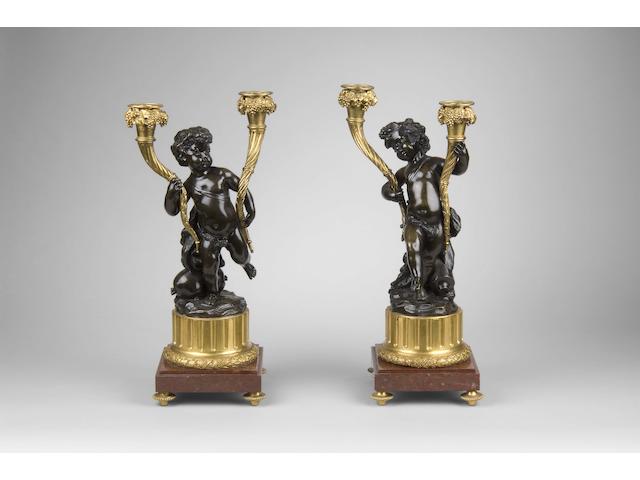 After Claude Michel Clodion (1738-1814): A pair of 19th Century French bronze and gilt bronze candelabra