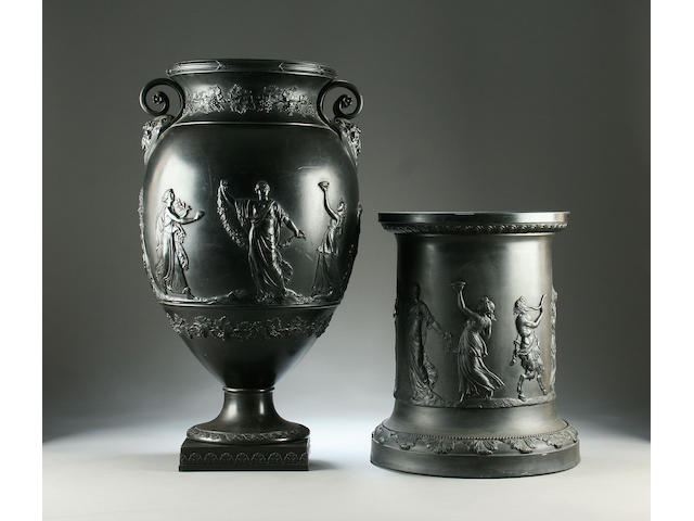 A large black basalt urn vase and associated Wedgwood stand