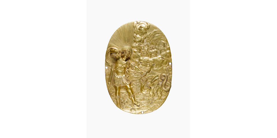 A pair of mid 17th century French gilt bronze oval plaques in high relief of Apollo slaying Python and of a seated Virtue/Fame