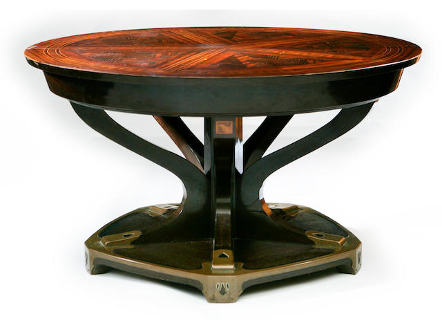 An Art Noveau rosewod and coromandel dining table