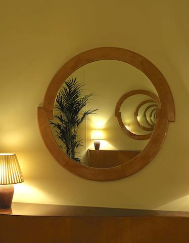 A pair of Art Deco circular birch and satinwood wall mirrors
