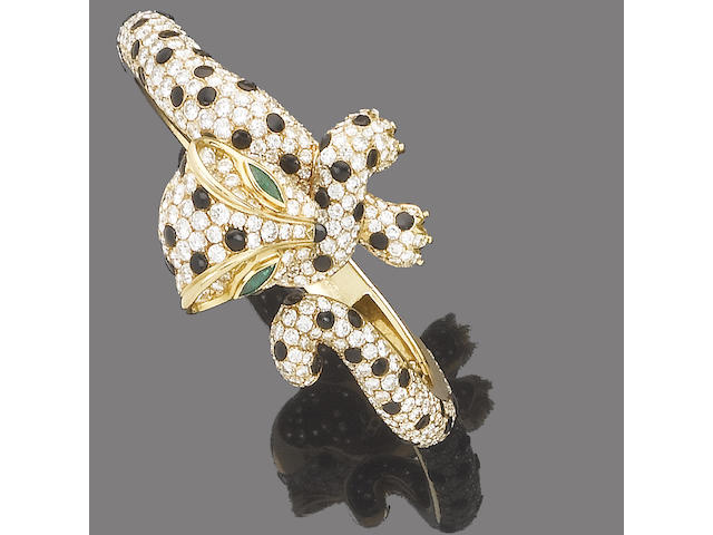 An emerald, diamond and onyx hinged bangle, by Fred