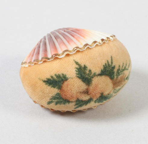 A painted velvet pincushion in shell