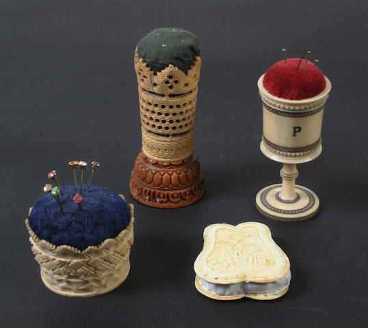 Four ivory and vegetable ivory pincushions