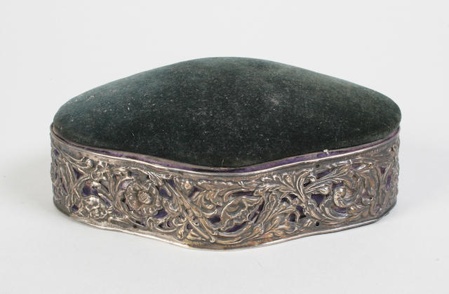 An octafoil silver mounted box with hinged pincushion top