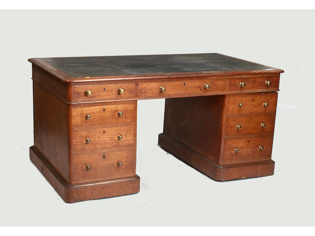 A Victorian oak twin pedestal desk