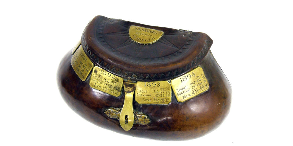 A fine 19th century heavily stitched leather pot bellied creel with belt loop and white painted interior