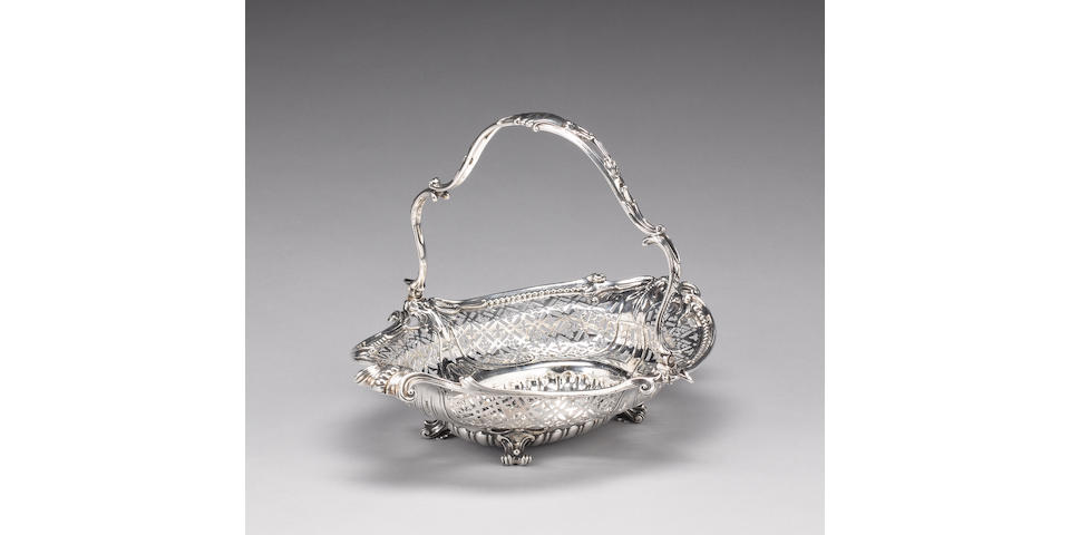 An early  George III silver swing-handled basket, maker's mark partially distorted, possibly by John Radburn, handle with maker's mark and lion passant, London 1764,