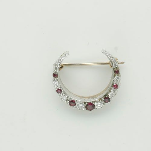 A ruby and diamond crescent brooch,