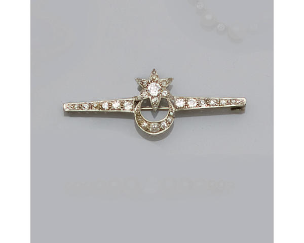 A diamond set star and crescent bar brooch,