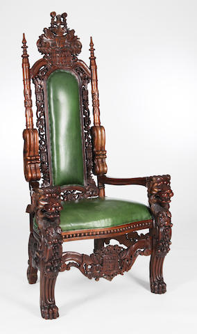 A 20th century heavily carved hardwood throne chair