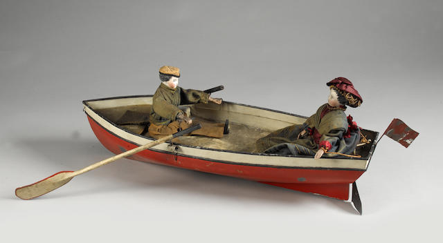 Tinplate clockwork boat with gentleman and lady dolls,