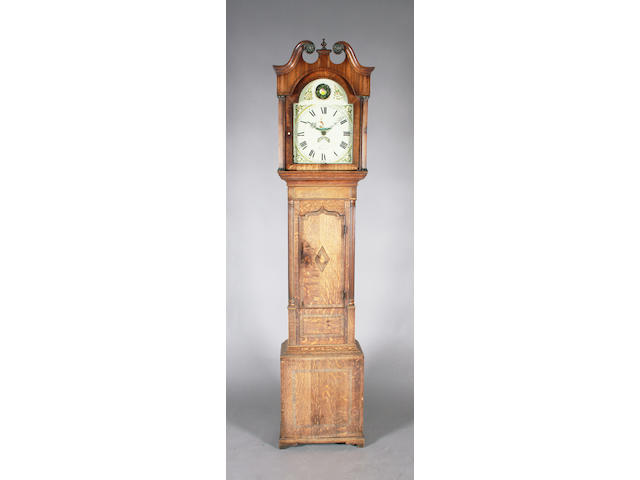 An early 19th century oak and mahogany longcase clock