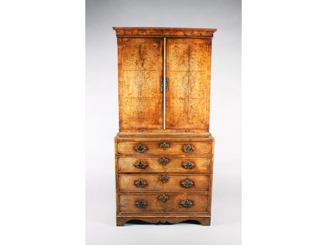 A George II figured walnut and herringbone banded cabinet-on-chest