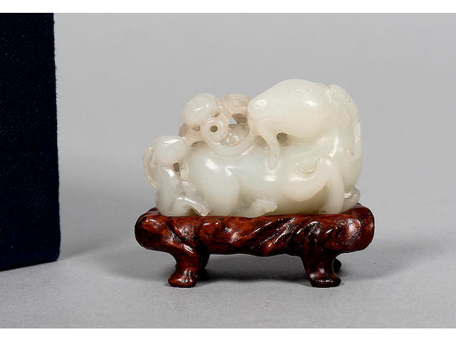 A Chinese carved jade figure of two goats and a peach