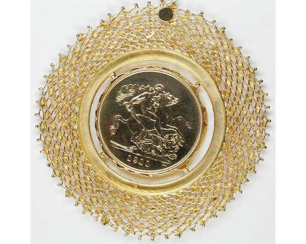 George V: Two pounds, 1911, in pendant mount, to open weave surround with applied disk and bead detail, on a fancy-link chain,