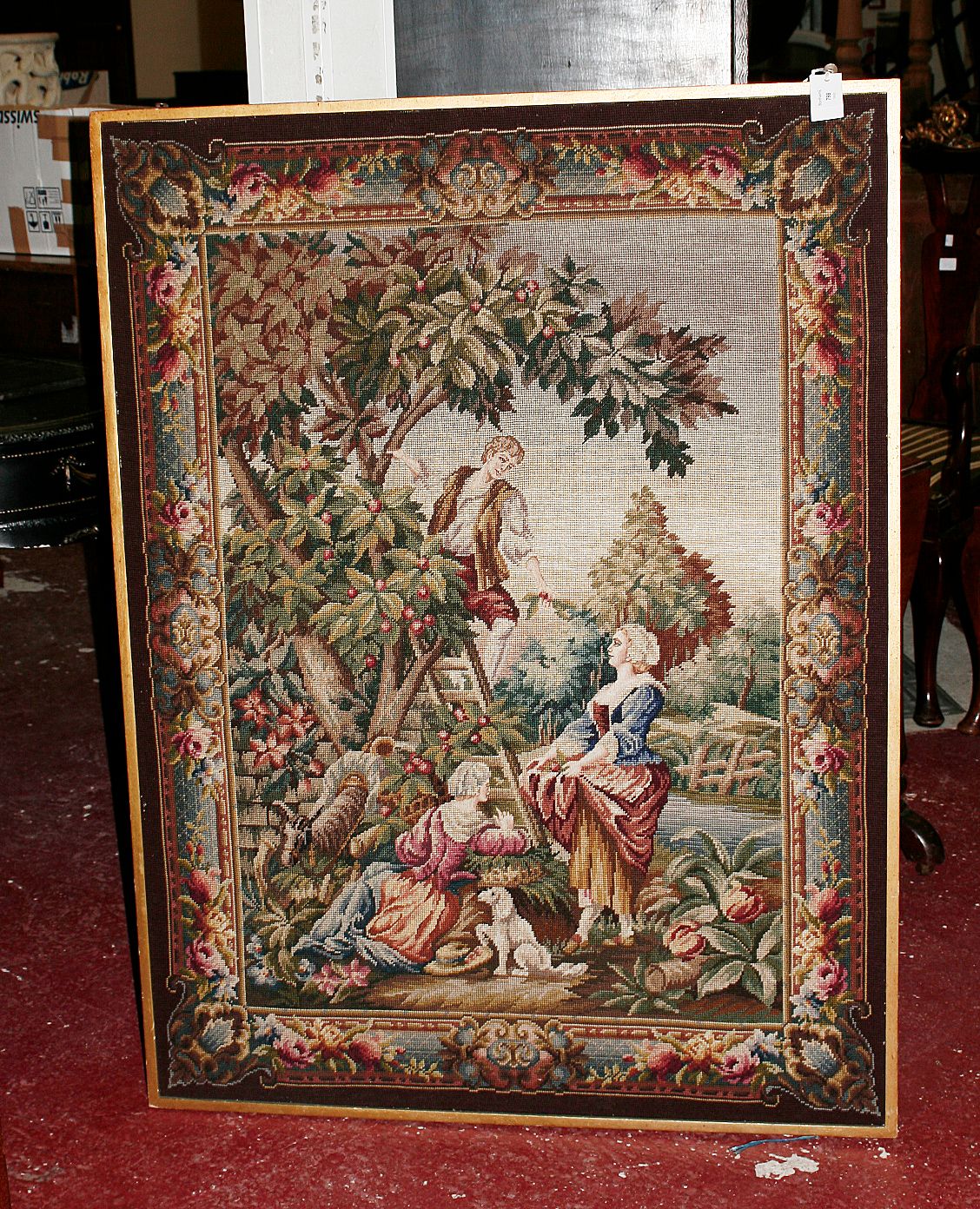 A framed tapestry panel