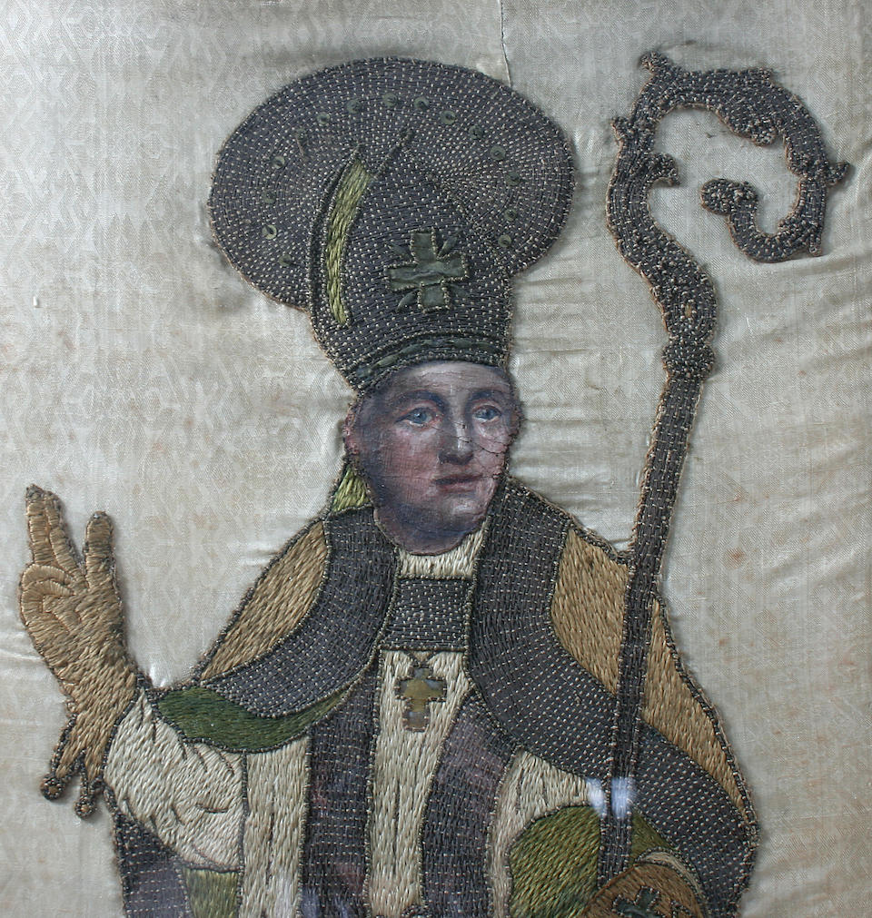 A pair of woolwork and painted silk panels of saints Circa 1800