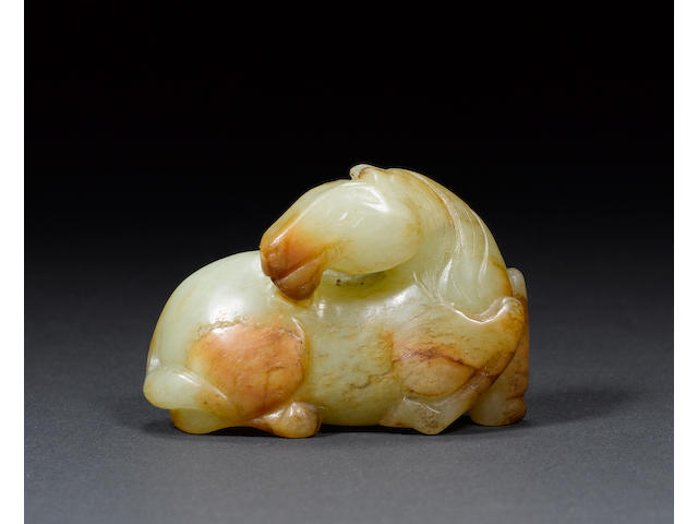 A charming mottled green celadon jade of a small horse Ming Dynasty