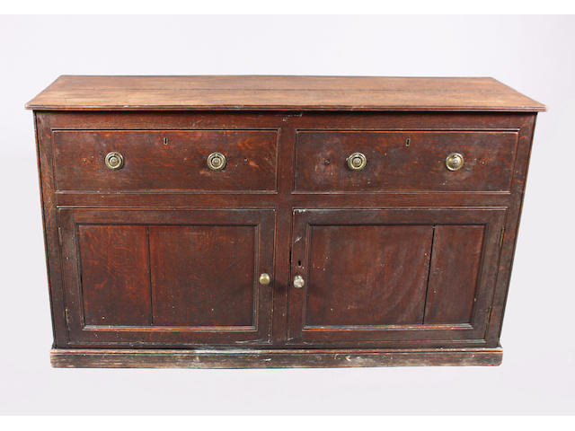 A 19th century and later oak cupboard dresser base