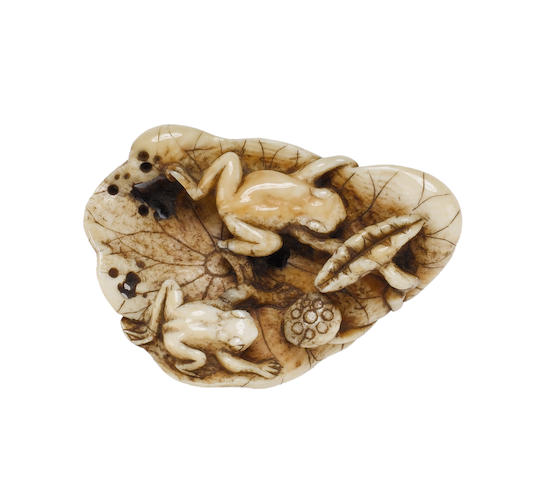 Three ivory animal netsuke, comprising: three puppies; a monkey on a deer; and frogs on a lotus leaf