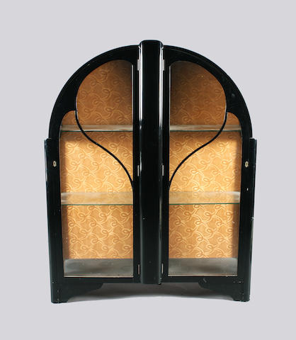 An Art Deco black finish china cabinet of arched form