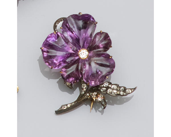 A carved amethyst and diamond flower brooch