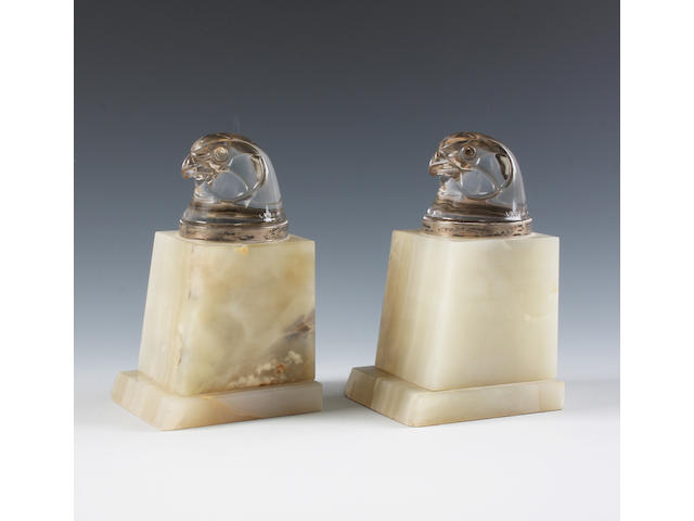 A pair of Lalique clear glass paperweights 'Tete d'&#201;pervier'